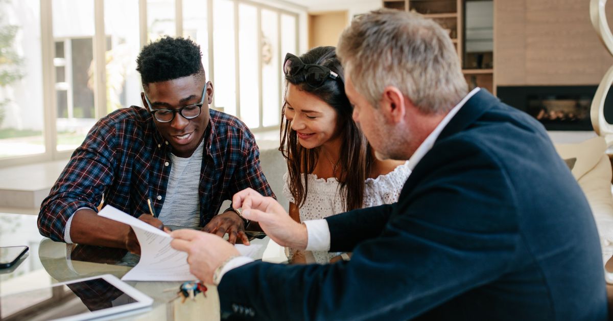 Team at work. Two men and a woman looking at a document in an office setting