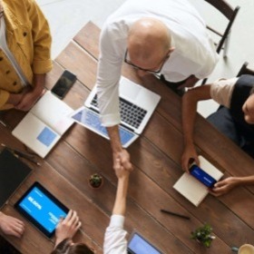 Team Meeting with Handshake over table