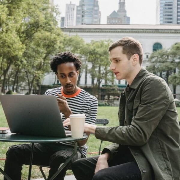 Two people looking at a laptop