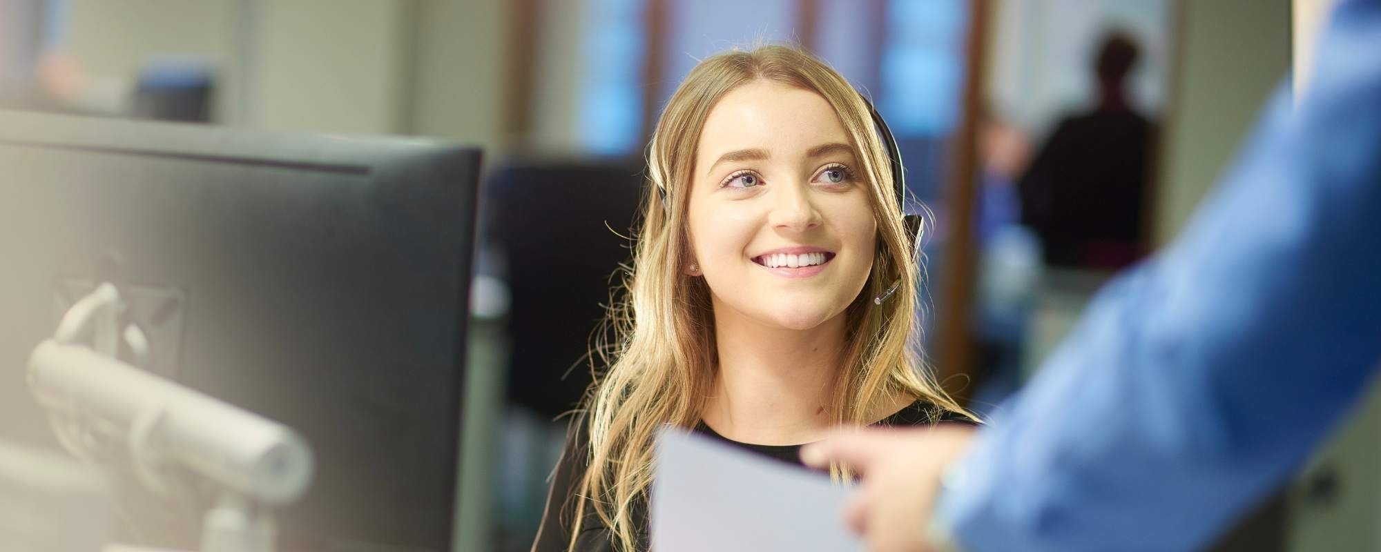 Happy sales person with phone headset