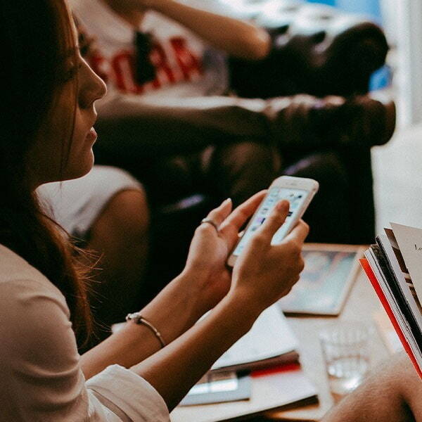 Woman using phone whole working